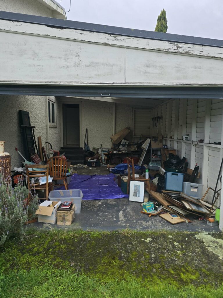 Garage containing unwanted items before rubbish clearance in Dannevirke