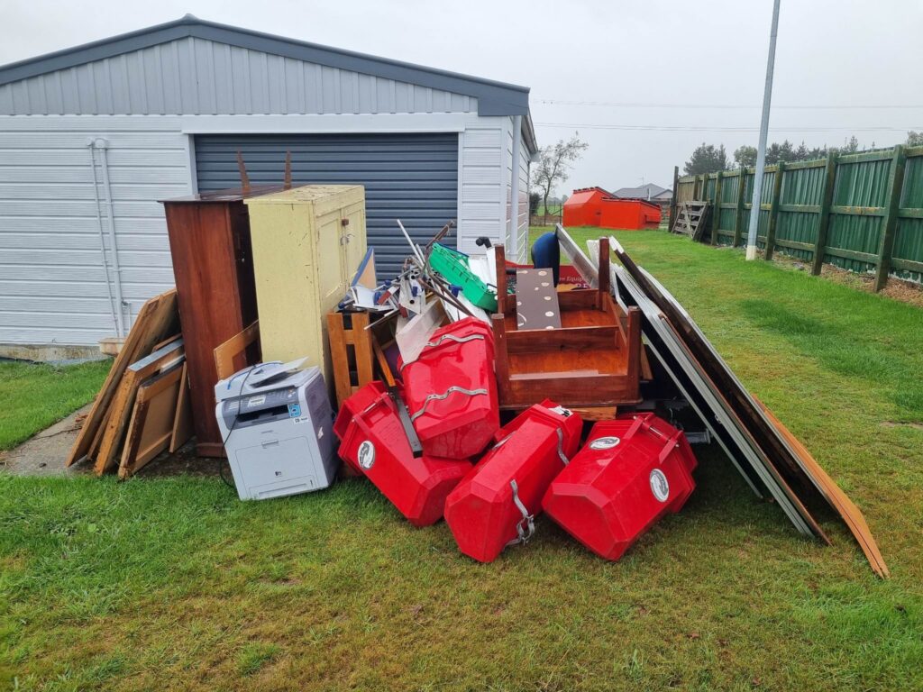 Unwanted furniture and equipment outside a school building before removal in Newbury